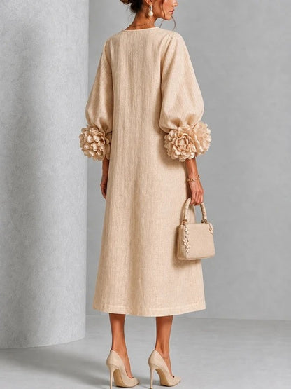 Vestido midi beige con estampado floral, botones y mangas florales extravagantes.